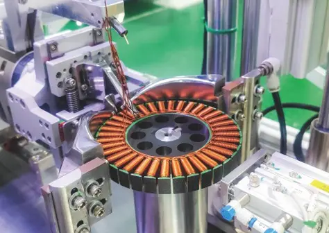 Close-up winding process detail with wire path and tooling